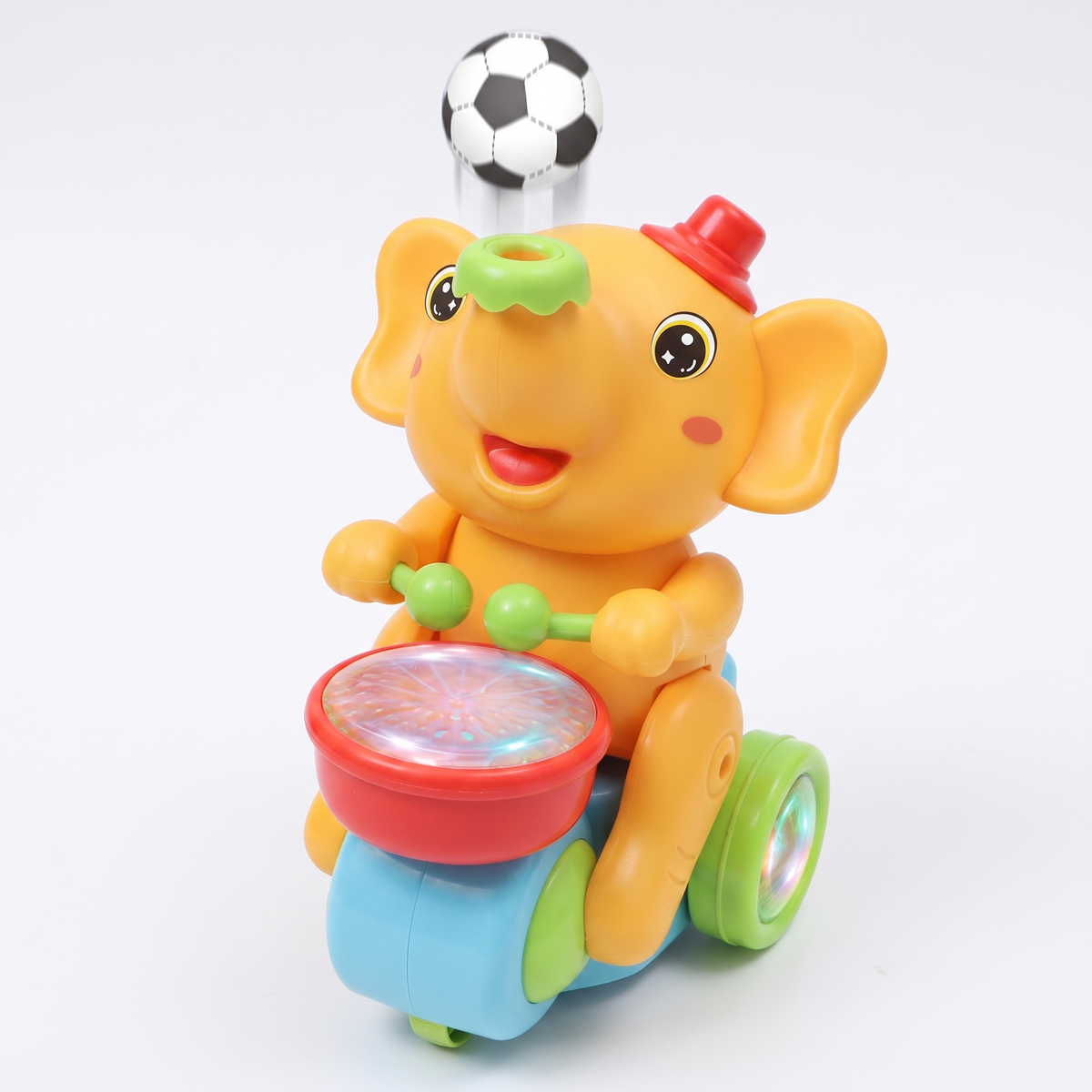 Elefante baterista musical amarillo con sombrero rojo, tambor con luces y pelota flotando