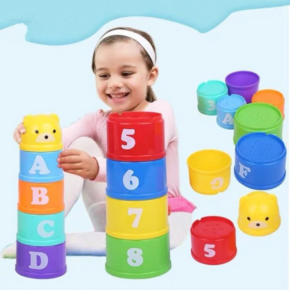 Niña armando la torre de vasos apilables con letras y números