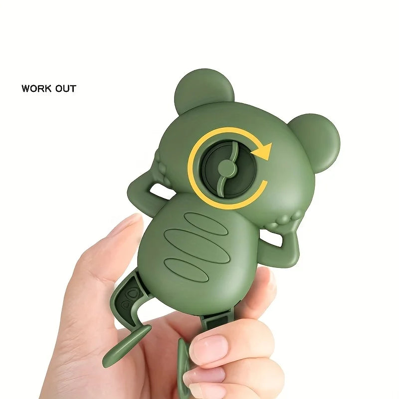 Mano dándole cuerda a la rana verde