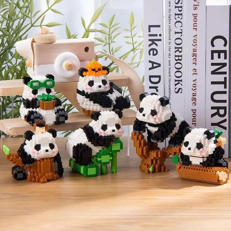 Seis pandas de micro bloques armados sobre un escritorio con libros